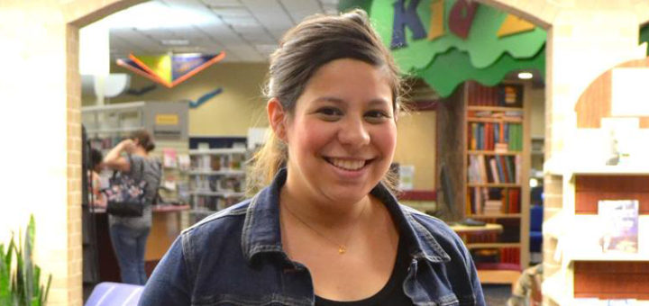 Rachel Flinn stands in library