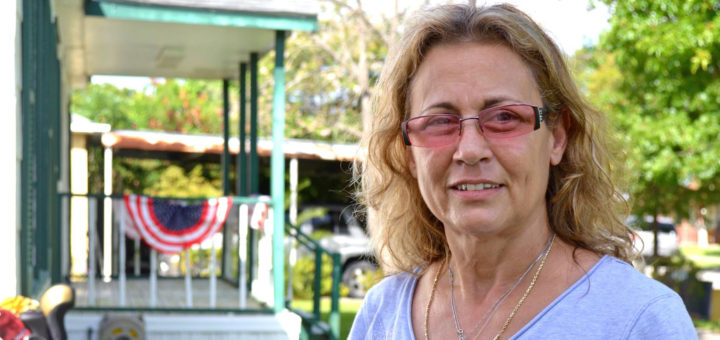 Sandra Campbell stands outside her house