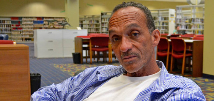 William Lewis sits at library