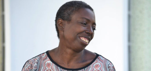 Angel Hodges sits on bench in front of library