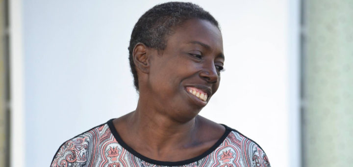 Angel Hodges sits on bench in front of library