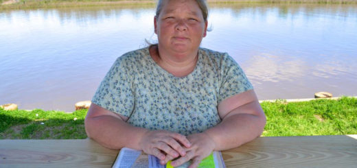 Woman reading Bible at park