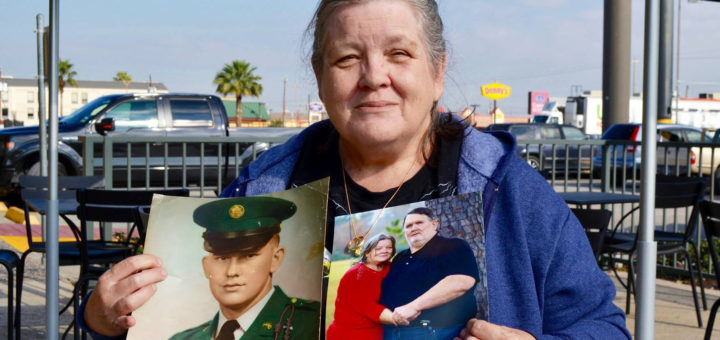 Carla Sherrod holds photos of her husband