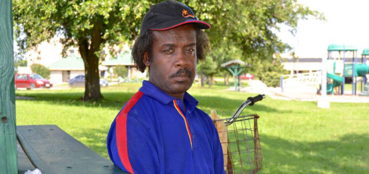 Man wearing Church's Chicken uniform at park