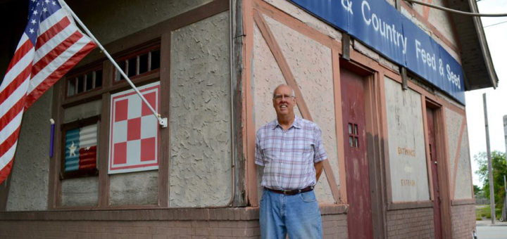 Man stands in front of his feed store