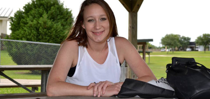 Woman sits at picnic table