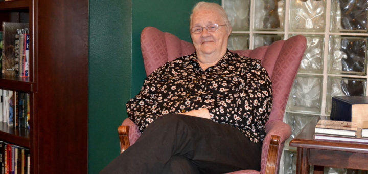 Frankie Johnson smiles while sitting in chair