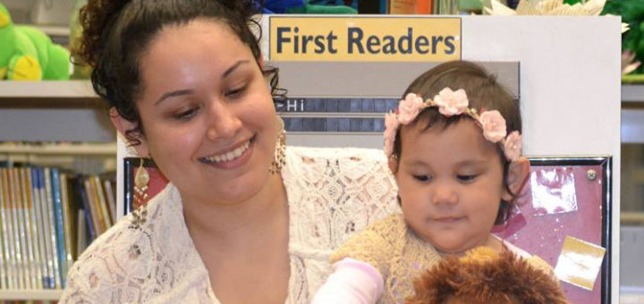 Genesis Torres reads book to daughter