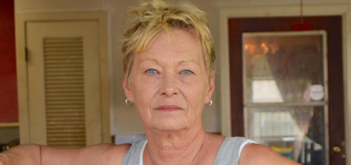 Woman stands in her garage