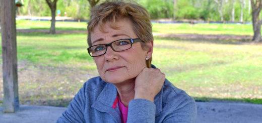Woman sits at picnic table