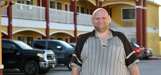 Joshua Johnson stands in motel parking lot