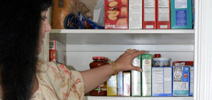 Laura Rupp arranging items in her pantry