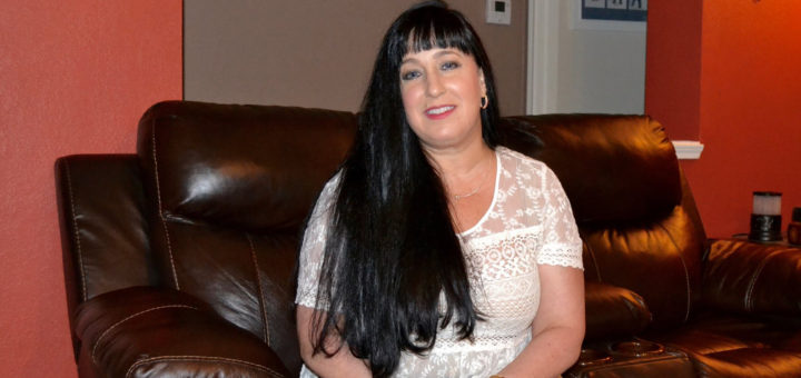 Laura Rupp sits on her couch