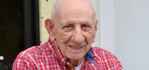 Leon McCraw sits outside library