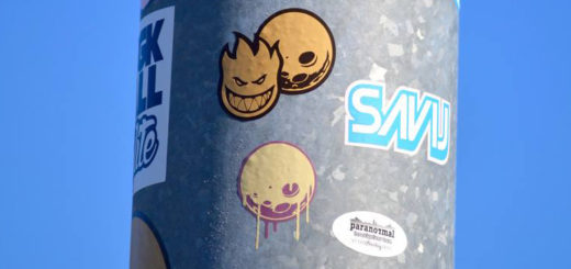 Logo stickers on a poll at the park