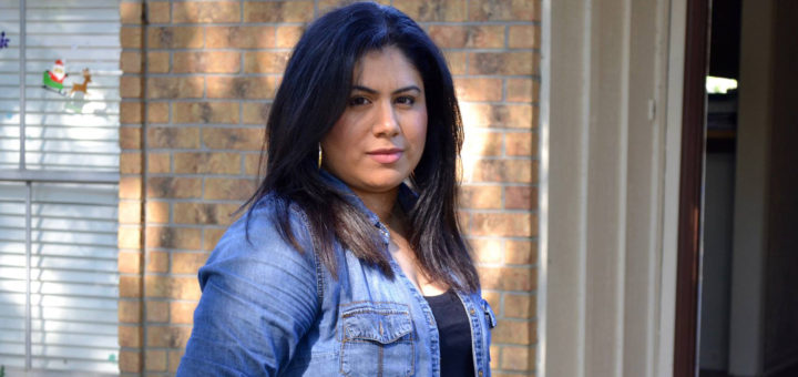 Lydia Rosales-Vega stands in her front yard