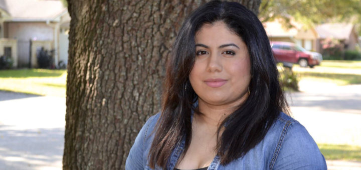 Lydia Rosales-Vega stands in her yard