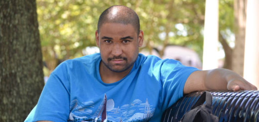 Lyneel Brimage sits on park bench