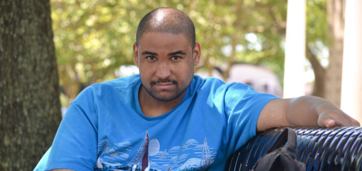 Lyneel Brimage sits on park bench