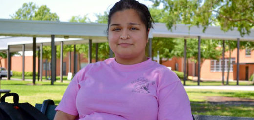 Nursing student sits on bench