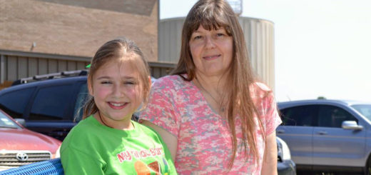 Peggy Hemmenway and granddaughter sit on bench