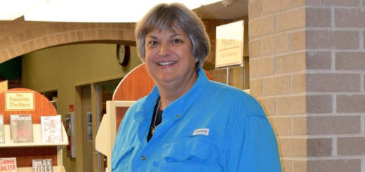 Robyne Gold standing inside library