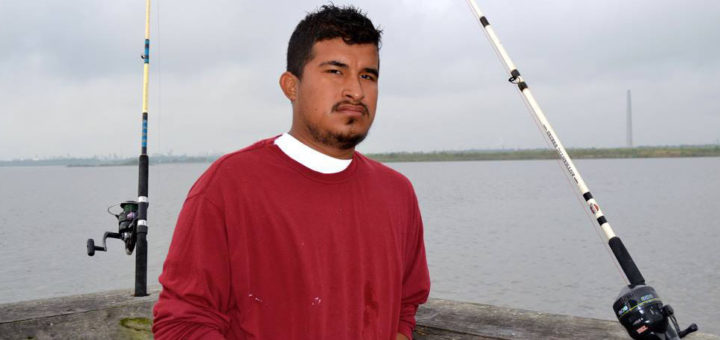 Young man fishing on pier