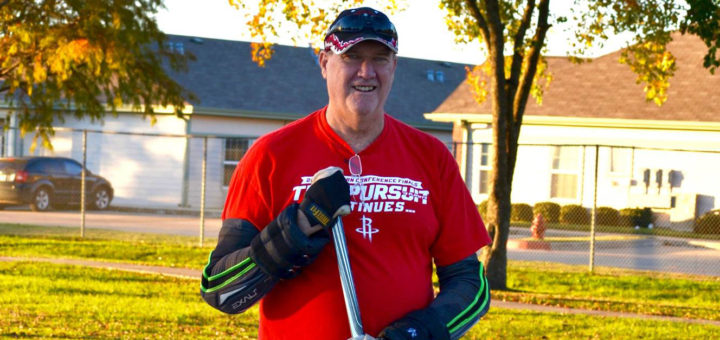 Stephen Lee roller-skates holding hockey stick