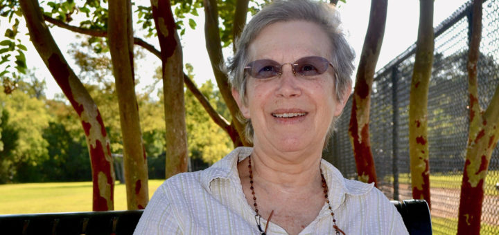 Woman sits on bench at park