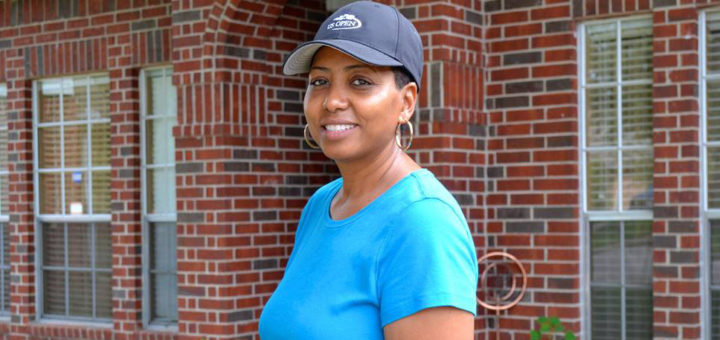 Woman in front of her house