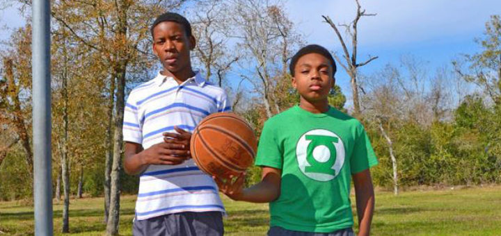 Two boys playing basketball
