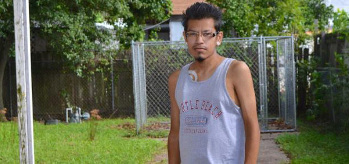 Young man stands in driveway