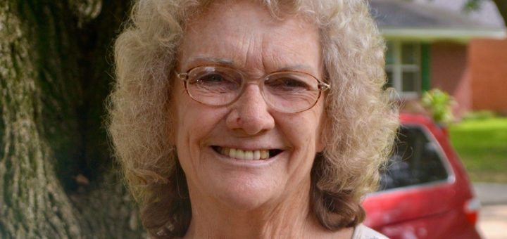 Woman stands near tree