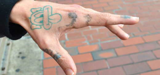 Young man shows comic art on his hand