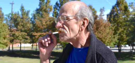 Man outside smoking cigarette
