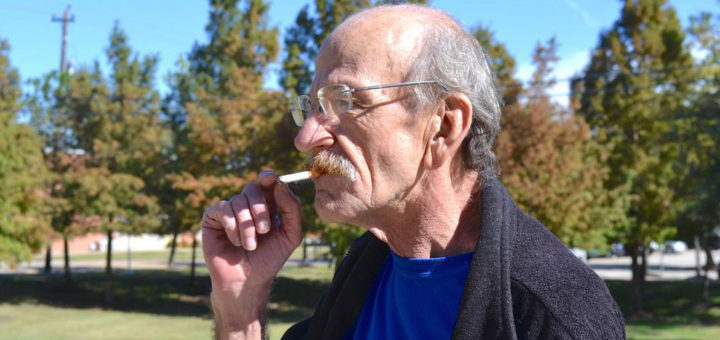 Man outside smoking cigarette