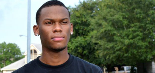 Young man stands in his driveway