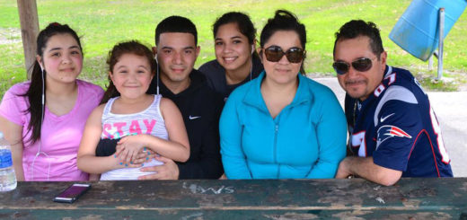 Family sits at picnic table