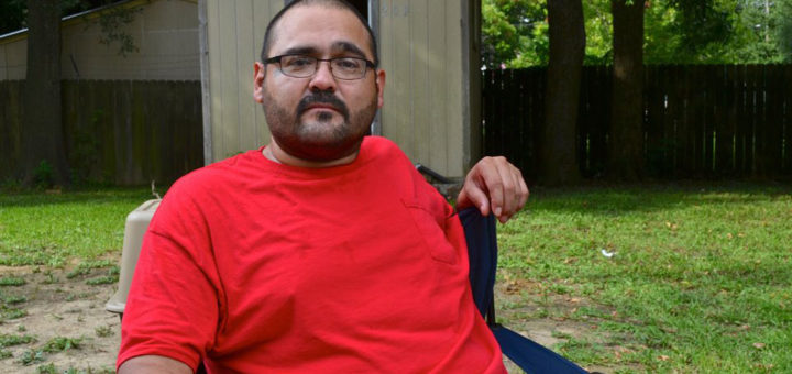 Man sits in his yard