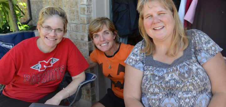 Three women hold garage sale