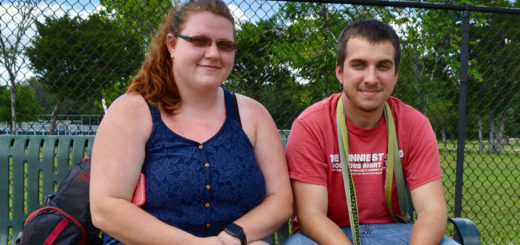 Katie and Andy sit on park bench