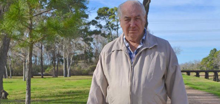 Retired longshoreman walks his dog at park