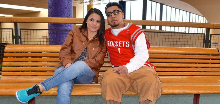 Couple sit on bench at mall