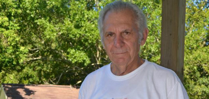 Mechanical engineer stands in his yard