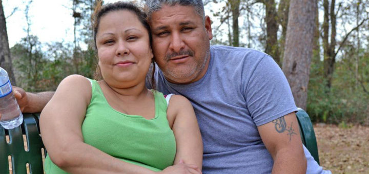 Couple sit on bench at park
