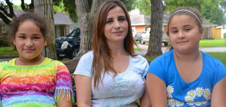 Mother sits with two daughters