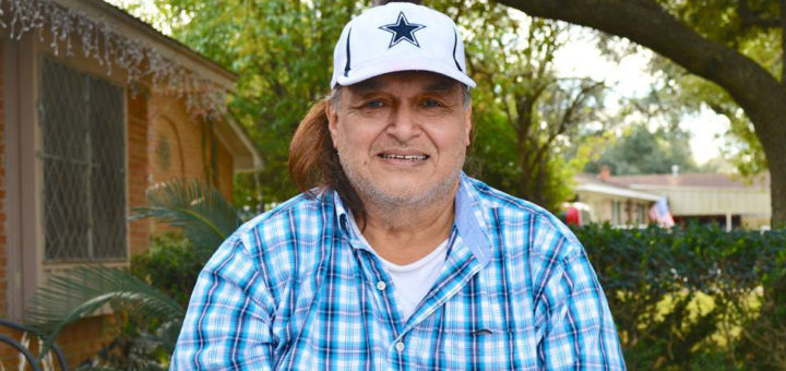 Retired grandpa sits in front yard