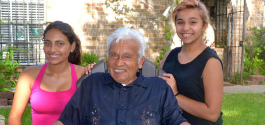 Man with two granddaughters in yard
