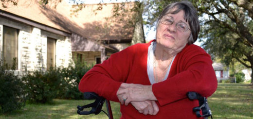 Woman sits in front of church