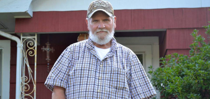 Former sheet metal mechanic in front of his home